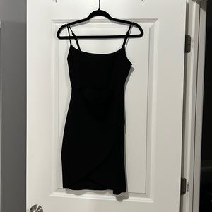 Lulus mini black dress. Cut out in middle with splayed front.